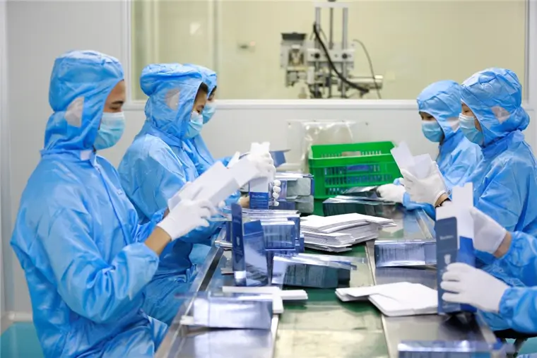 Operator inspecting finished toothpaste products